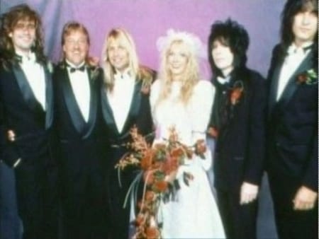 Emi Canyn and Mick Mars with their band mates at their wedding